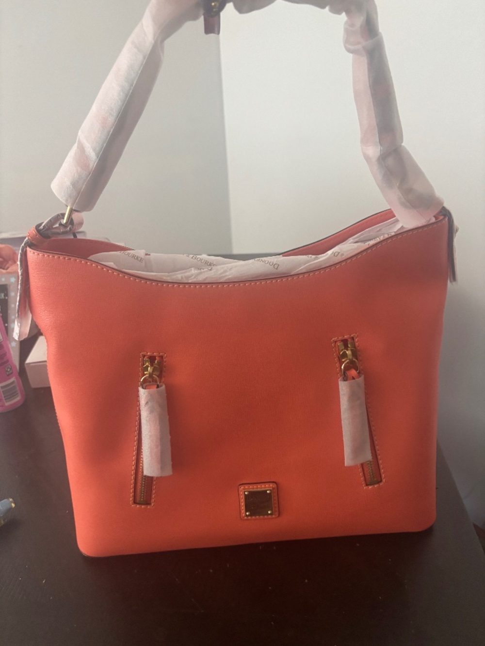 with:  Title: Dooney & Bourke Orange Handbag – New/Never Used